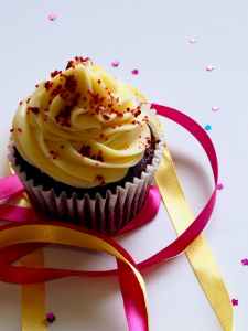 chocolate cupcake with white and red toppings